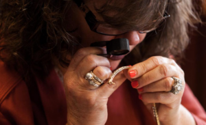 Jennifer Pratt examining jewelry